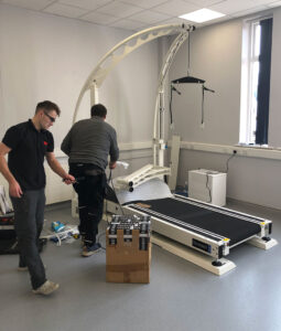 two men installing treadmill