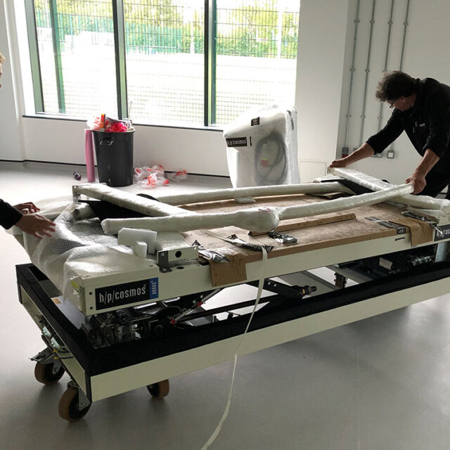 two people installing treadmill