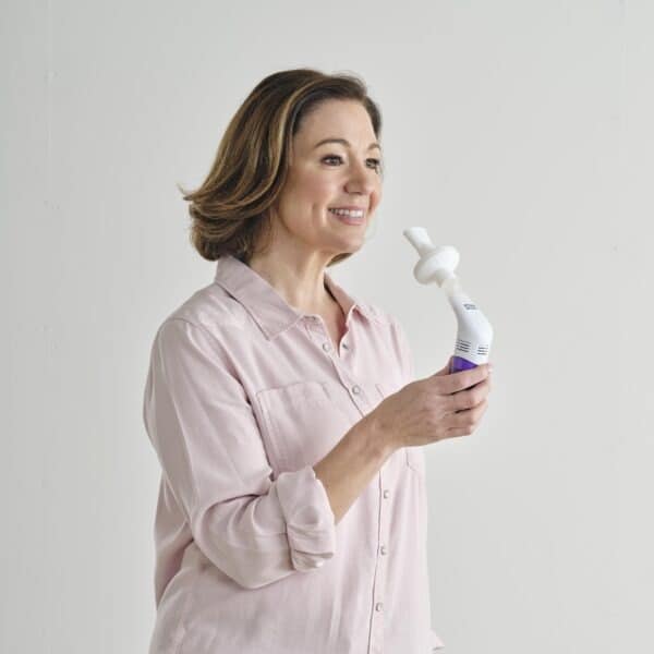 Woman holding PowerBreathe device