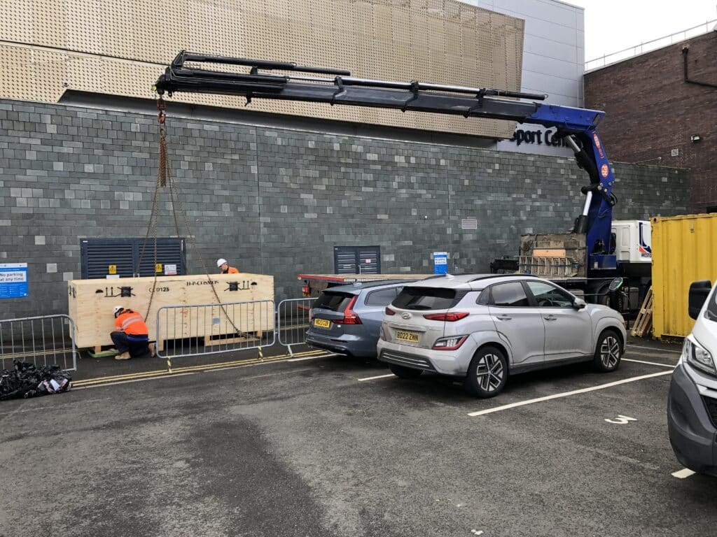 The crane lifting the h/p/cosmos treadmill to the first floor