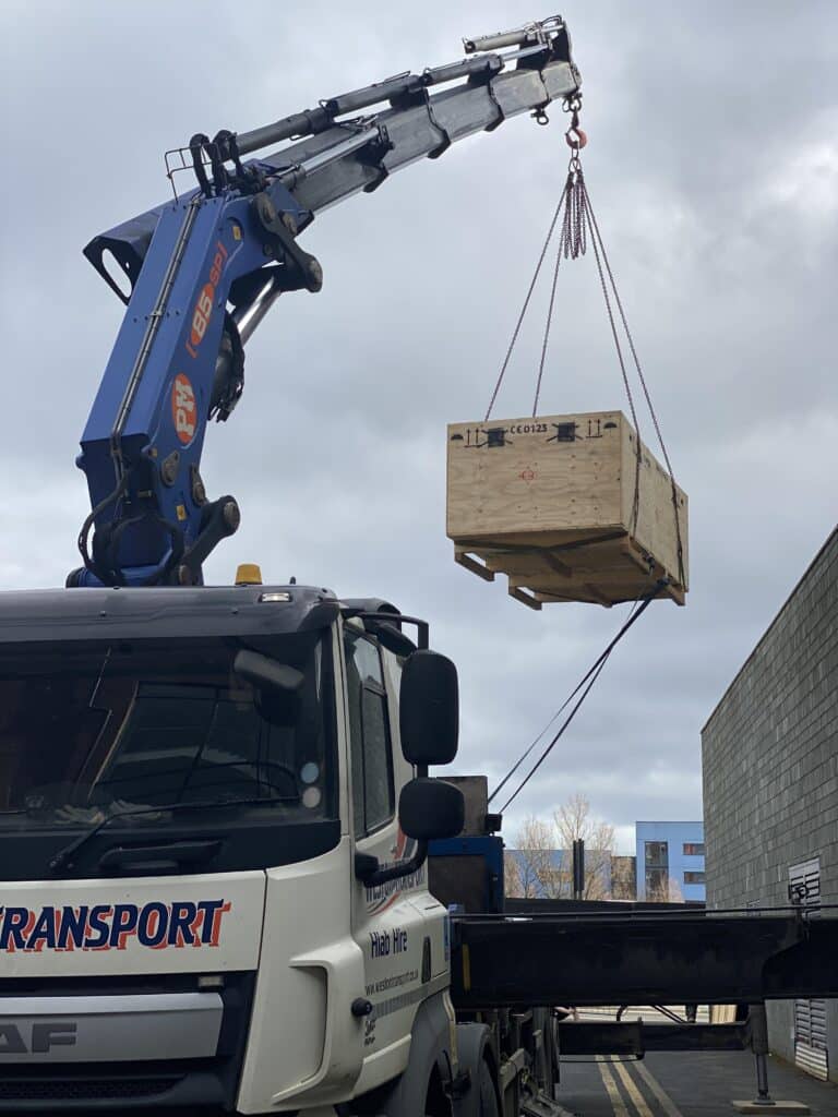 The crane lifting the h/p/cosmos treadmill to the first floor